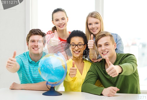 Image of five smiling student with earth globe at school