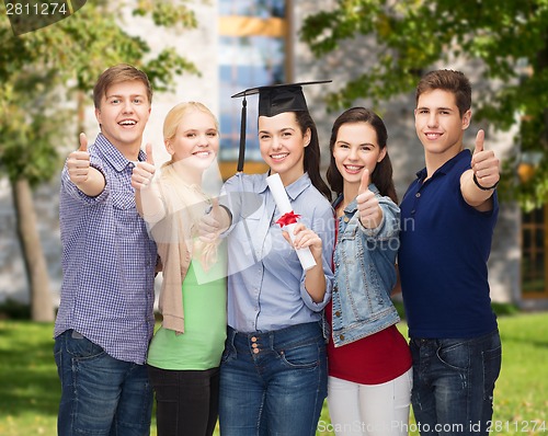 Image of group of students with diploma showing thumbs up