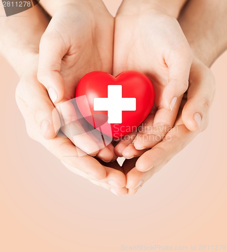 Image of male and female hands with red heart