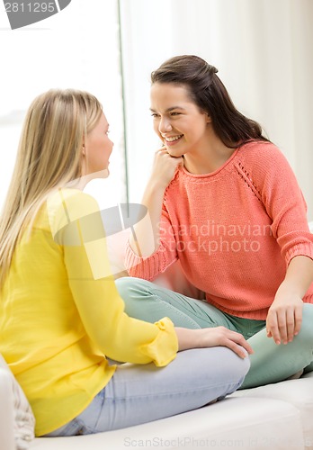 Image of two girlfriends having a talk at home