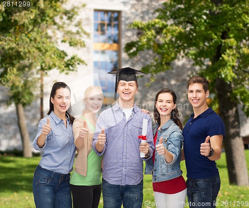 Image of group of students with diploma showing thumbs up