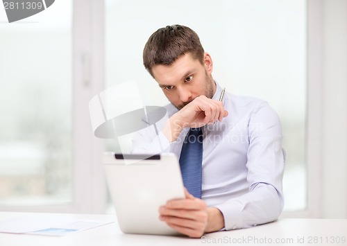 Image of stressed businessman with tablet pc and documents