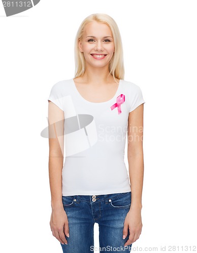 Image of smiling woman with pink cancer awareness ribbon