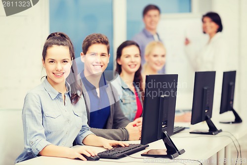 Image of students with computer monitor at school