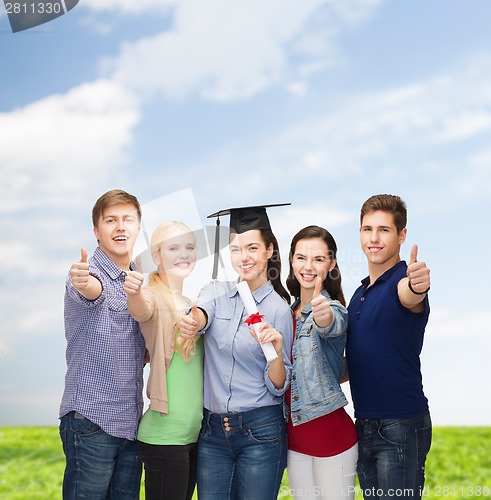 Image of group of students with diploma showing thumbs up