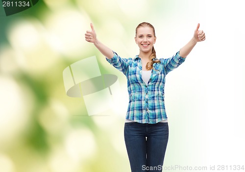 Image of smiling girl in casual clothes showing thumbs up