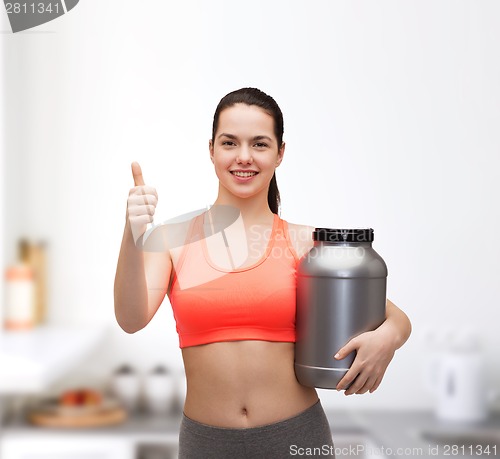 Image of teenage girl with jar of protein showing thumbs up