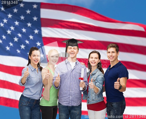 Image of group of students with diploma showing thumbs up