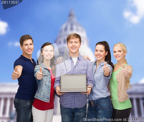 Image of smiling students with laptop computer