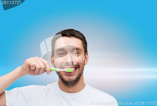 Image of smiling young man with toothbrush