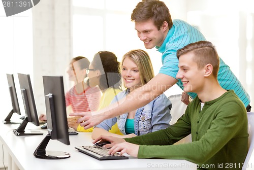 Image of smiling students in computer class at school