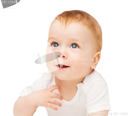 Image of smiling baby lying on floor and looking up