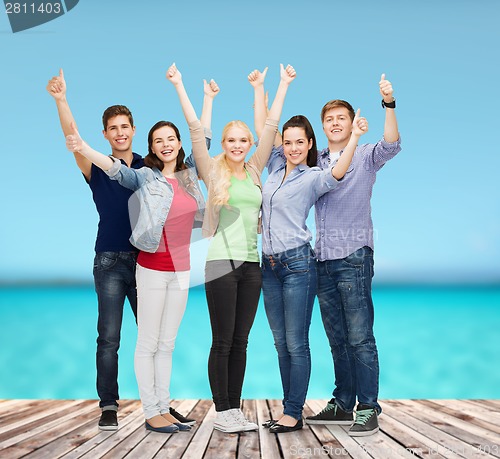 Image of group of smiling students showing thumbs up