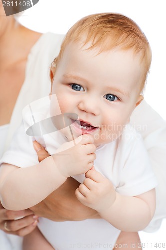 Image of close up of mother holding smiling baby