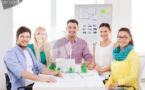 Image of smiling architects working in office