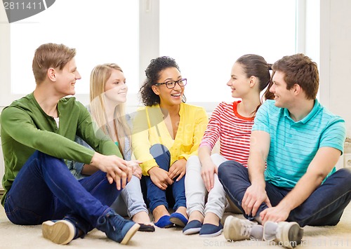 Image of five smiling teenagers having fun at home