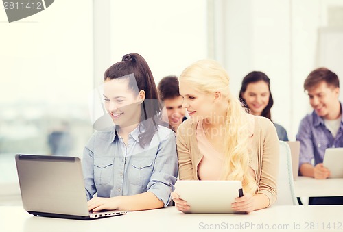 Image of students with laptop, tablet pc and notebooks