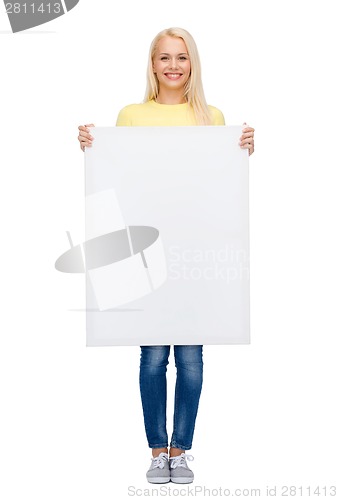 Image of smiling woman in sweater with blank white board