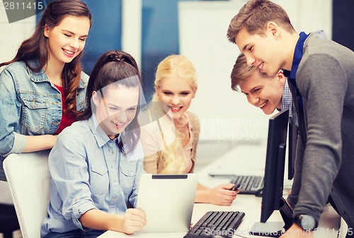Image of students with computer monitor and tablet pc
