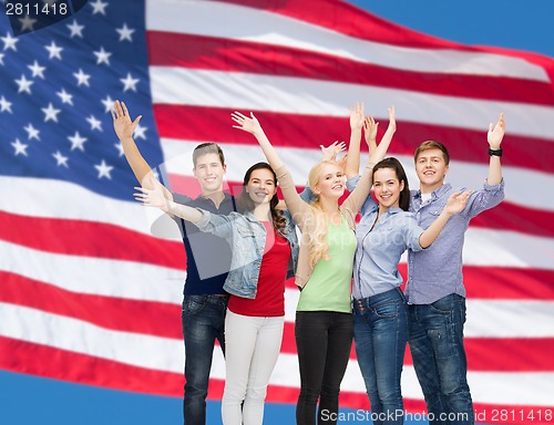 Image of group of smiling students waving hands
