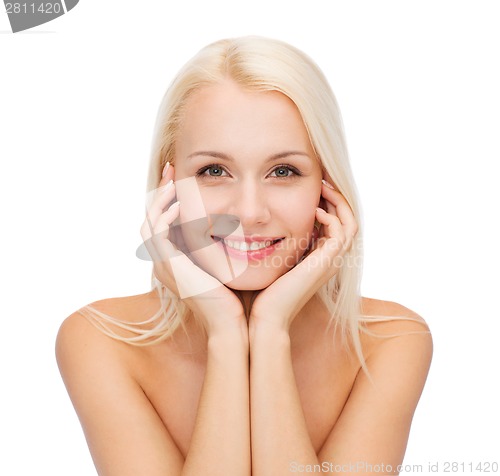 Image of face of beautiful woman touching her face skin