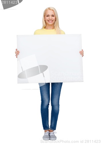 Image of smiling woman in sweater with blank white board