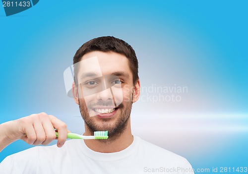 Image of smiling young man with toothbrush