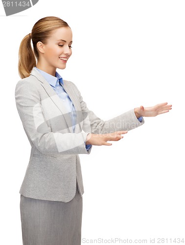 Image of smiling businesswoman pointing to something