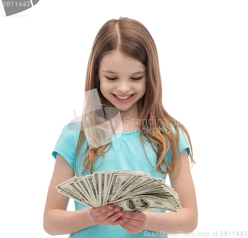 Image of smiling little girl looking at dollar cash money