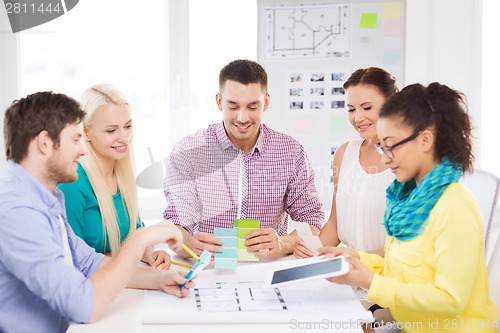 Image of smiling interior designers working in office