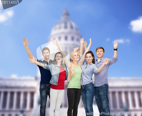 Image of group of smiling students waving hands