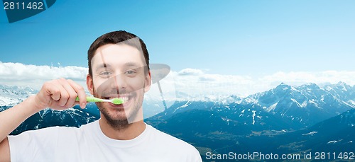 Image of smiling young man with toothbrush