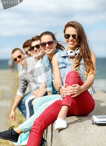 Image of teenage girl hanging out with friends outdoors