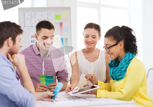 Image of smiling interior designers working in office