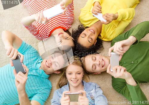 Image of group of smiling people lying down on floor