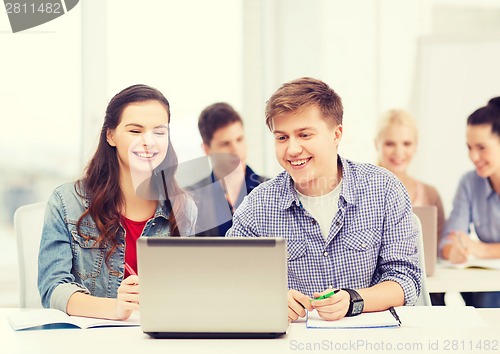 Image of students with laptop and notebooks at school