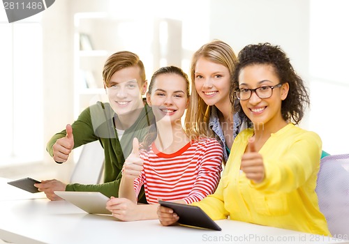 Image of smiling students with tablet pc at school