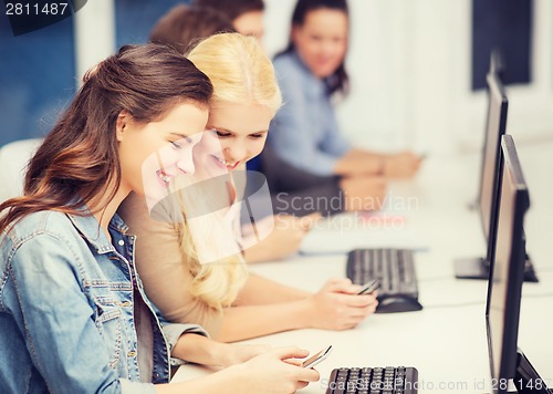 Image of students with computer monitor and smartphones
