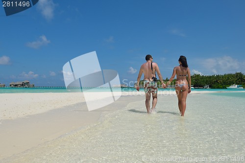 Image of happy young couple have fun on beach