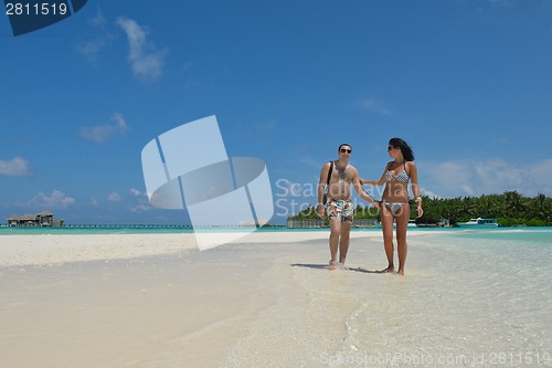 Image of happy young couple have fun on beach