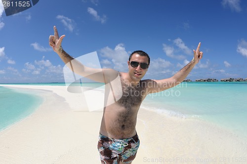 Image of young man have fun and relax on beach