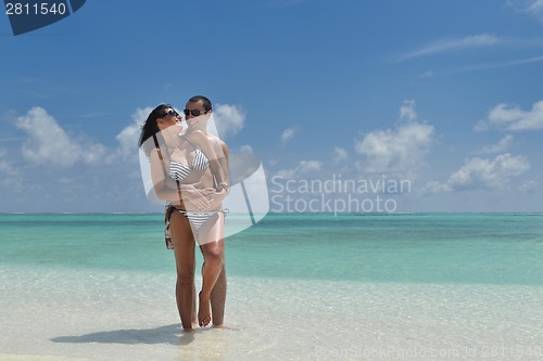 Image of happy young couple have fun on beach