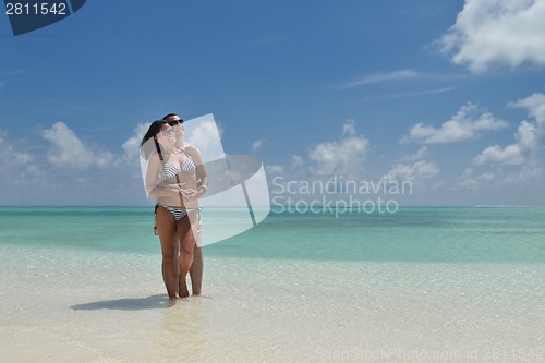 Image of happy young couple have fun on beach