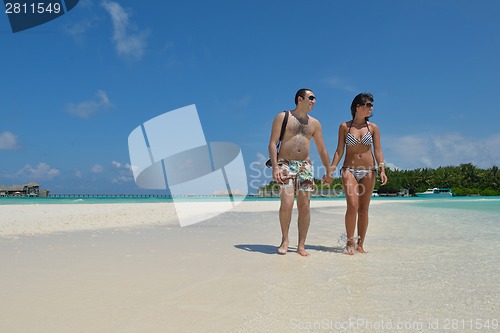 Image of happy young couple have fun on beach