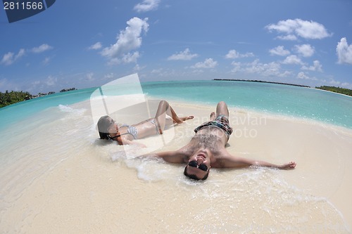 Image of happy young couple have fun on beach