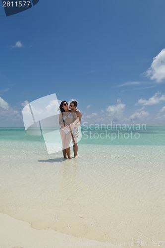Image of happy young couple have fun on beach