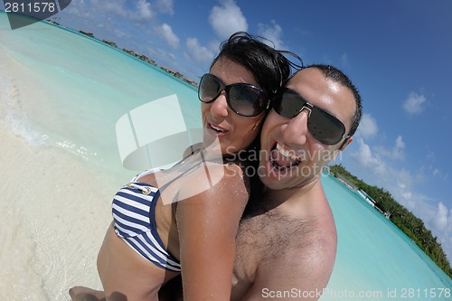 Image of happy young couple have fun on beach