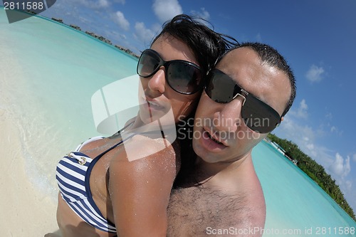 Image of happy young couple have fun on beach