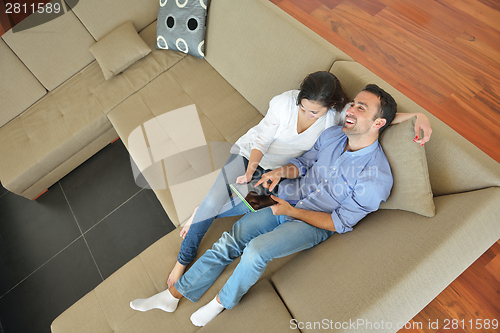 Image of couple at home using tablet computer