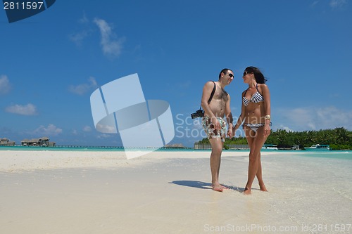 Image of happy young couple have fun on beach